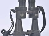 a pair of binoculars sitting on a white surface