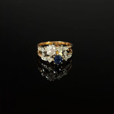 a close up of a gold and diamond ring on a black surface