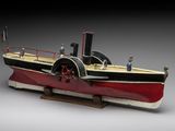 an old model of a steam powered boat on a wooden stand