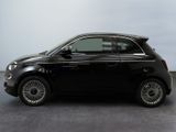 the small black car is parked on the concrete floor in the room