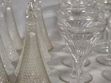 a lot of wine glasses that are sitting on a table