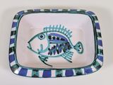 a blue and white plate with a fish design on it