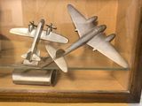 a glass display case with a model of a plane in it
