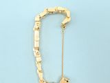 an image of a gold brooch with a chain attached to it