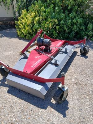 an image of a lawn mower sitting on the ground