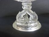 a clear glass candle holder on a black table