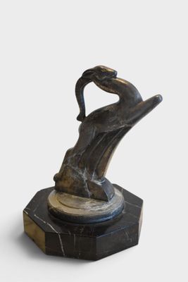 statue of a man holding a woman ' s hand on top of a marble base