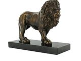 statue en bronze représentant un lion, posée sur un socle noir, sur fond blanc