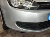 a car that has been dented and is parked in a garage