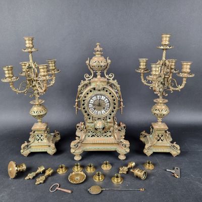 many different types of clocks and candles on the table