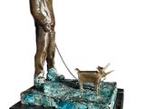 bronze statue of a man with a dog on a chain