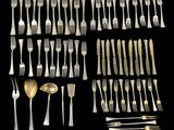 a large collection of silverware including forks and spoons