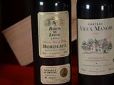 two bottles of wine sitting next to each other on a table