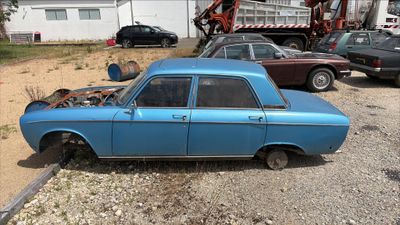 a blue car that is parked in a lot