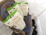 three bags of cat litter sitting on a chair