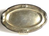 silver plate on a white surface with a handle on it