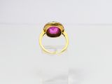 a gold ring with a pink stone in the middle of it