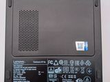 a black laptop with a red button on it