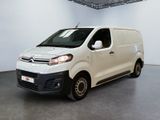 the white van is parked in the large room of the building