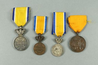 three medals and a medal are sitting on a table