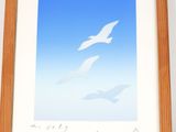 a picture of a picture of two birds flying in the sky