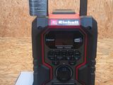 an image of a black and red portable radio with a box