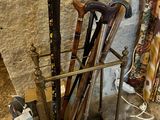 many different types of walking canes on display