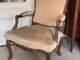 a chair that is sitting in a room with a rug on the floor