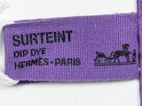 purple label on a purple tie with a horse drawn carriage on it