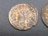three old coins sitting on top of a table next to each other