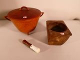a brown pot and a wooden box on a table