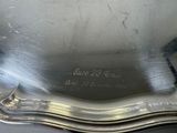 a silver plate with writing on it sitting on a table