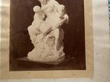 an old photo of a statue of a woman holding a child