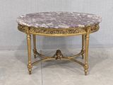 a marble top table with a gold frame and a marble top