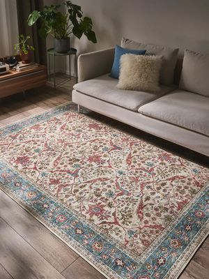 a living room with a couch and a rug on the floor