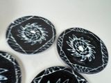 three black and white plates with designs on them on a white surface