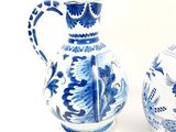 two blue and white vases sitting next to each other