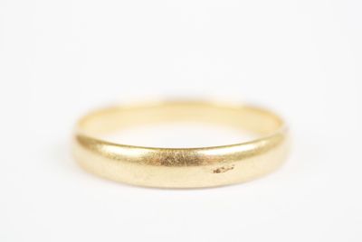 a close up of a gold ring on a white surface