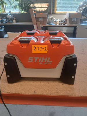 an orange and white machine sitting on top of a wooden table