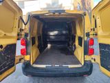 a yellow van that is parked in a parking lot