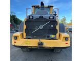 the back end of a large yellow truck parked in a parking lot