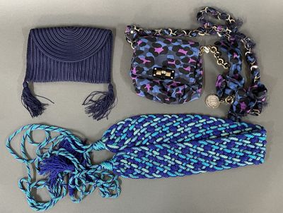purple and blue handbag, scarf, hat, and purse laid out on a table