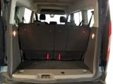 the back of a van with the door open and the back seats folded down