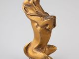 a gold statue of a dog sitting on its hind legs