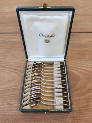 a box with a set of silverware in it on a wooden table