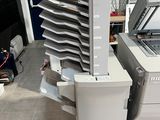 a machine that is sitting next to a stack of papers