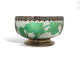 a green and white bowl sitting on top of a table