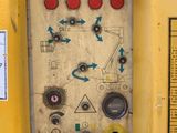 a yellow machine with buttons and arrows on it