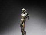a bronze statue of a man standing on a pedestal