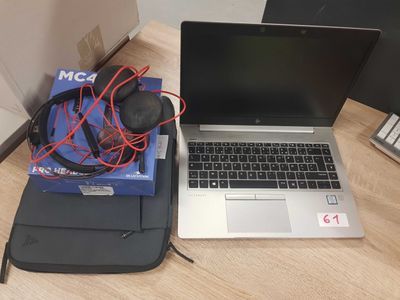 a laptop and headphones sitting on a desk next to a laptop